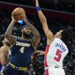 
              Denver Nuggets center DeMarcus Cousins (4) looks to pass as Detroit Pistons guard Frank Jackson (5) defends during the first half of an NBA basketball game, Tuesday, Jan. 25, 2022, in Detroit. (AP Photo/Carlos Osorio)
            