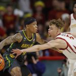 
              Iowa State forward Aljaz Kunc (5) works to steal the ball from Baylor guard James Akinjo (11) during the first half of an NCAA college basketball game, Saturday, Jan. 1, 2022, in Ames. (AP Photo/Matthew Putney)
            