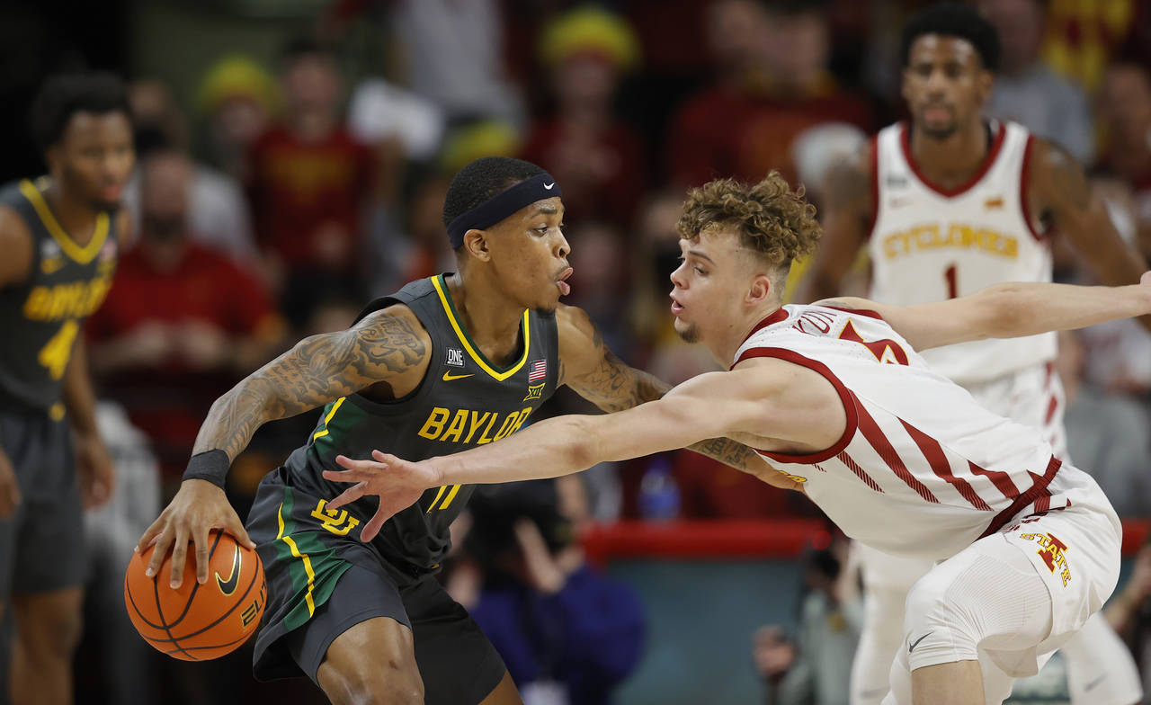 Iowa State forward Aljaz Kunc (5) works to steal the ball from Baylor guard James Akinjo (11) durin...