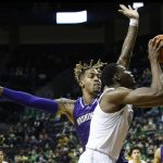 
              Oregon center N'Faly Dante shoots against Washington forward Nate Roberts in the first half of an NCAA college basketball game in Eugene, Ore., Sunday, Jan. 23, 2022. (AP Photo/Thomas Boyd)
            