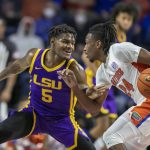 
              LSU forward Mwani Wilkinson (5) defends against Florida guard Phlandrous Fleming Jr. (24) during the first half of an NCAA college basketball game Wednesday, Jan. 12, 2022, in Gainesville, Fla. (AP Photo/Alan Youngblood)
            