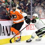 
              Philadelphia Flyers' Keith Yandle, left, and Dallas Stars' Luke Glendening battle along the boards during the first period of an NHL hockey game, Monday, Jan. 24, 2022, in Philadelphia. Yandle tied the NHL record for consecutive games played with 964 on Monday. (AP Photo/Derik Hamilton)
            