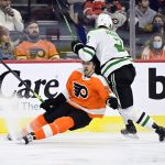 
              Philadelphia Flyers' James van Riemsdyk, left, falls to the ice as he is hit by Dallas Stars' Jani Hakanpaa during the second period of an NHL hockey game, Monday, Jan. 24, 2022, in Philadelphia. (AP Photo/Derik Hamilton)
            