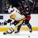 
              Columbus Blue Jackets forward Boone Jenner, right, chases the puck behind Pittsburgh Penguins defenseman John Marino during the second period of an NHL hockey game in Columbus, Ohio, Friday, Jan. 21, 2022. (AP Photo/Paul Vernon)
            