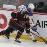 
              Ottawa Senators defenseman Thomas Chabot pressures Buffalo Sabres right wing Kyle Okposo along the boards during the first period of an NHL hockey game, Tuesday, Jan. 18, 2022 in Ottawa, Ontario. (Adrian Wyld/The Canadian Press via AP)
            