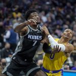 
              Los Angeles Lakers guard Russell Westbrook (0) and Sacramento Kings forward Chimezie Metu (7) battle for position under the basket in the first quarter of an NBA basketball game in Sacramento, Calif., Wednesday, Jan. 12, 2022. (AP Photo/José Luis Villegas)
            