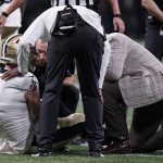 
              New Orleans Saints quarterback Taysom Hill (7) is helped after injury against the Atlanta Falcons during the first half of an NFL football game, Sunday, Jan. 9, 2022, in Atlanta. (AP Photo/Brynn Anderson)
            
