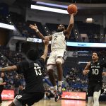 
              Connecticut's R.J. Cole shoots over Butler's Jayden Taylor (13) during the second half of an NCAA college basketball game Tuesday, Jan. 18, 2022, in Hartford, Conn. (AP Photo/Jessica Hill)
            