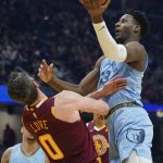 
              Memphis Grizzlies' Jaren Jackson Jr. (13) drives to the basket against Cleveland Cavaliers' Kevin Love (0) in the first half of an NBA basketball game, Tuesday, Jan. 4, 2022, in Cleveland. (AP Photo/Tony Dejak)
            