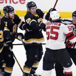 
              New Jersey Devils defenseman Mason Geertsen (55) is held back by linesman Mike Cvik, right, as he challenges the Boston Bruins during the first period of an NHL hockey game Tuesday, Jan. 4, 2022, in Boston. (AP Photo/Charles Krupa)
            