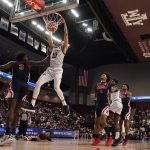 
              Texas A&M forward Ethan Henderson (10) dunks over Mississippi center Nysier Brooks (3) during the second half of an NCAA college basketball game Tuesday, Jan. 11, 2022, in College Station, Texas. (AP Photo/Sam Craft)
            