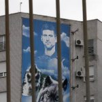 
              A billboard depicting Serbian tennis player Novak Djokovic hangs on a building in Belgrade, Serbia, Thursday, Jan. 6, 2022. The Australian government has denied No. 1-ranked Djokovic entry to defend his title in the year's first tennis major and canceled his visa because he failed to meet the requirements for an exemption to the country's COVID-19 vaccination rules. (AP Photo/Darko Vojinovic)
            