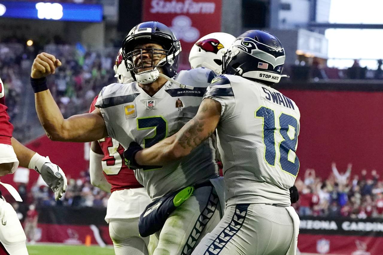 Seattle Seahawks quarterback Russell Wilson, left, celebrates his touchdown run against the Arizona...