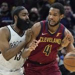 
              Cleveland Cavaliers' Evan Mobley (4) tries to get past Brooklyn Nets' James Harden (13) in the second half of an NBA basketball game, Monday, Jan. 17, 2022, in Cleveland. (AP Photo/Tony Dejak)
            