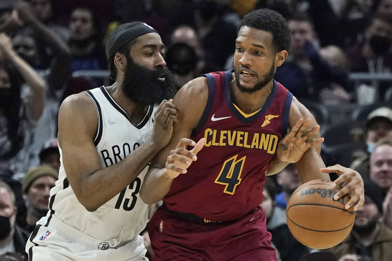 Cleveland Cavaliers' Evan Mobley (4) tries to get past Brooklyn Nets' James Harden (13) in the seco...