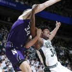 
              Michigan State's Julius Marble, right, and Northwestern's Matthew Nicholson battle for a rebound during the first half of an NCAA college basketball game, Saturday, Jan. 15, 2022, in East Lansing, Mich. Northwestern won 64-62. (AP Photo/Al Goldis)
            