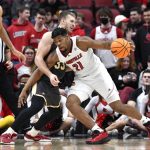 
              Louisville forward Sydney Curry (21) tries to fight his way past Boston College center James Karnik (33) during the first half of an NCAA college basketball game in Louisville, Ky., Wednesday, Jan. 19, 2022. (AP Photo/Timothy D. Easley)
            