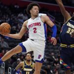 
              Detroit Pistons guard Cade Cunningham (2) passes the ball as Denver Nuggets forward Jeff Green (32) defends during the second half of an NBA basketball game, Tuesday, Jan. 25, 2022, in Detroit. (AP Photo/Carlos Osorio)
            