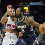 
              Denver Nuggets guard Davon Reed (9) drives as Detroit Pistons guard Rodney McGruder (17) defends during the first half of an NBA basketball game, Tuesday, Jan. 25, 2022, in Detroit. (AP Photo/Carlos Osorio)
            