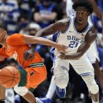 
              Miami guard Isaiah Wong, left, and Duke forward A.J. Griffin (21) chase the ball during the second half of an NCAA college basketball game in Durham, N.C., Saturday, Jan. 8, 2022. (AP Photo/Gerry Broome)
            