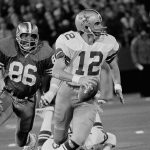 
              FILE - San Francisco 49ers defensive end Cedrick Hardman (86) eyes Dallas Cowboys quarterback Roger Staubach (12) moments before sacking him for a loss in first quarter in San Francisco, Dec. 12, 1977. The 49ers-Cowboys playoff history is a rich one from back-to-back conference title games in the early 1970s, the iconic “Catch” in the 1981 season and then the heated rivalry in the 1990s. (AP Photo/File)
            