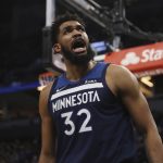 
              Minnesota Timberwolves center Karl-Anthony Towns (32) reacts after scoring a basket during the first half of an NBA basketball game against the Golden State Warriors, Sunday Jan. 16, 2022, in Minneapolis. (AP Photo/Stacy Bengs)
            