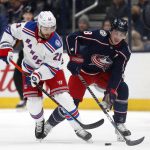 
              New York Rangers forward Barclay Goodrow, left, chases the puck in front of Columbus Blue Jackets defenseman Zach Werenski during the first period of an NHL hockey game in Columbus, Ohio, Thursday, Jan. 27, 2022. (AP Photo/Paul Vernon)
            