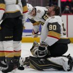 
              Vegas Golden Knights defenseman Dylan Coghlan (52) checks on Golden Knights goaltender Robin Lehner (90) after Lehner took a puck to the helmet during the second period of an NHL hockey game against the Washington Capitals, Monday, Jan. 24, 2022, in Washington. (AP Photo/Evan Vucci)
            