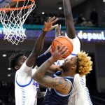 
              Villanova guard Justin Moore, right, drives to the basket against DePaul forward David Jones, left, and forward Yor Anei during the first half of an NCAA college basketball game in Chicago, Saturday, Jan. 8, 2022. (AP Photo/Nam Y. Huh)
            