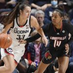 
              Connecticut's Caroline Ducharme (33) dribbles as Louisville's Kianna Smith (14) defends in the second half of an NCAA college basketball game, Sunday, Dec. 19, 2021, in Uncasville, Conn. (AP Photo/Jessica Hill)
            