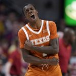 
              Texas guard Andrew Jones (1) celebrates during a timeout during the first half of an NCAA college basketball game against Iowa State, Saturday, Jan. 15, 2022, in Ames, Iowa. (AP Photo/Charlie Neibergall)
            
