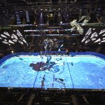 The ice appears to shatter before a massive tentacle during a light show before an NHL hockey game at Climate Pledge Arena between the Seattle Kraken and the San Jose Sharks, Thursday, Jan. 20, 2022, in Seattle. (AP Photo/Elaine Thompson)