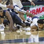 
              Butler guard Bo Hodges (1) and Villanova forward Jermaine Samuels (23) dive on a loose ball during the first half of an NCAA college basketball game, Sunday, Jan. 16, 2022, in Philadelphia, Pa. (AP Photo/Laurence Kesterson)
            