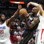 
              Los Angeles Clippers forward Justise Winslow (20) and center Isaiah Hartenstein, right, defend against Miami Heat center Dewayne Dedmon, center, during the first half of an NBA basketball game, Friday, Jan. 28, 2022, in Miami. (AP Photo/Lynne Sladky)
            