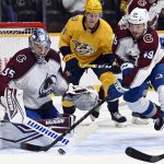 
              Colorado Avalanche defenseman Samuel Girard (49) moves the puck away from goaltender Darcy Kuemper (35) during the second period of an NHL hockey game Tuesday, Jan. 11, 2022, in Nashville, Tenn. (AP Photo/Mark Zaleski)
            