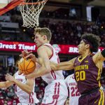 
              Wisconsin's Ben Carlson grabs a defensive rebound against Minnesota's Eylijah Stephens (20) during the first half of an NCAA college basketball game Sunday, Jan. 30, 2022, in Madison, Wis. (AP Photo/Andy Manis)
            