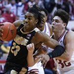 
              Purdue's Jaden Ivey (23) is defended by Indiana's Trey Galloway (32) and another Indiana player during the first half of an NCAA college basketball game Thursday, Jan. 20, 2022, in Bloomington, Ind. (Darron Cummings)
            