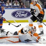 
              A puck gets past Philadelphia Flyers goaltender Martin Jones (35) for a goal by New York Islanders center Mathew Barzal during the second period of an NHL hockey game, Tuesday, Jan. 25, 2022, in Elmont, N.Y. (AP Photo/Corey Sipkin)
            