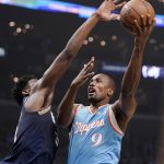 
              Los Angeles Clippers center Serge Ibaka, right, shoots as Memphis Grizzlies forward Jaren Jackson Jr. defends during the first half of an NBA basketball game Saturday, Jan. 8, 2022, in Los Angeles. (AP Photo/Mark J. Terrill)
            