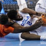 
              Oregon State forward Ahmad Rand, left, and UCLA forward Cody Riley go after a loose ball during the first half of an NCAA college basketball game Saturday, Jan. 15, 2022, in Los Angeles. (AP Photo/Mark J. Terrill)
            