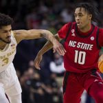 
              North Carolina State's Breon Pass (10) drives next to Notre Dame's Prentiss Hubb (3) during the first half of an NCAA college basketball game Wednesday, Jan. 26, 2022, in South Bend, Ind. (AP Photo/Robert Franklin)
            