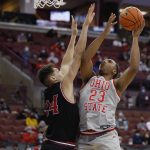
              Ohio State's Zed Key, right, shoots over IUPUI's Jonah Carrasco during the second half of an NCAA college basketball game Tuesday, Jan. 18, 2022, in Columbus, Ohio. (AP Photo/Jay LaPrete)
            
