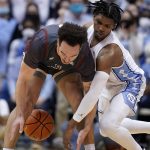 
              North Carolina guard Caleb Love, right, and Boston College guard Jaeden Zackery chase the ball during the second half of an NCAA college basketball game in Chapel Hill, N.C., Wednesday, Jan. 26, 2022. (AP Photo/Gerry Broome)
            