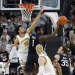 
              Butler guard Bo Hodges (1) passes out from under then basket as Providence forward Justin Minaya (15) defends during the first half of an NCAA college basketball game, Sunday, Jan. 23, 2022, in Providence, R.I. (AP Photo/Mary Schwalm)
            