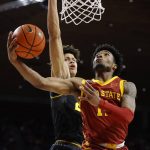
              Iowa State guard Tyrese Hunter (11) finds a basket past Missouri forward Trevon Brazile (23) during the first half of an NCAA college basketball game, Saturday, Jan. 29, 2022, in Ames. (AP Photo/Matthew Putney)
            