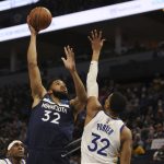 
              Minnesota Timberwolves center Karl-Anthony Towns (32) shoots the ball over Golden State Warriors forward Otto Porter Jr. (32) during the first half of an NBA basketball game, Sunday Jan. 16, 2022, in Minneapolis. (AP Photo/Stacy Bengs)
            