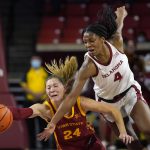 
              Iowa State guard Ashley Joens (24) and Oklahoma guard Kennady Tucker (4) reach for the ball in the second half of an NCAA college basketball game Wednesday, Jan. 5, 2022, in Norman, Okla. (AP Photo/Sue Ogrocki)
            