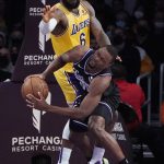
              Sacramento Kings forward Harrison Barnes, right, is fouled by Los Angeles Lakers forward LeBron James (6) during the first half of an NBA basketball game Tuesday, Jan. 4, 2022, in Los Angeles. (AP Photo/Marcio Jose Sanchez)
            