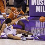 
              Texas guard Courtney Ramey (3) strips the ball away from TCU guard Micah Peavy (0) in the first half of an NCAA college basketball game in Fort Worth, Texas, Tuesday, Jan. 25, 2022. (AP Photo/Gareth Patterson)
            