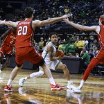 
              Oregon guard Jacob Young (42) looks to pass the ball as Utah's Both Gach (2), Lazar Stefanovic (20) and Branden Carlson defend during the first half of an NCAA college basketball game in Eugene, Ore., Saturday, Jan. 1, 2022. (AP Photo/Thomas Boyd)
            